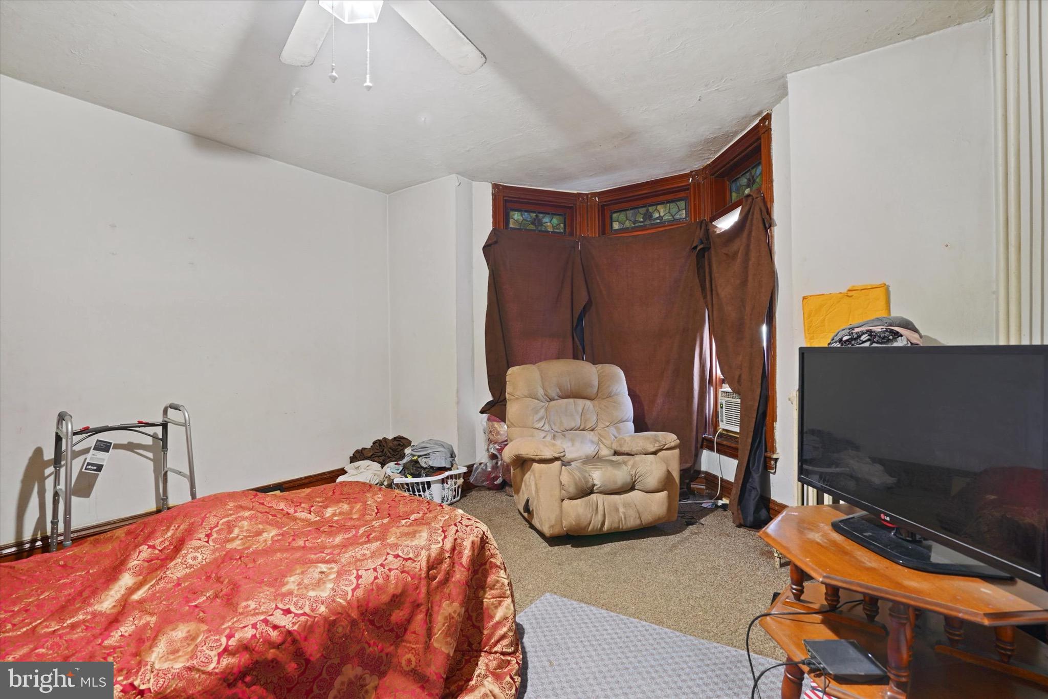 933 North 12th Street Reading, PA 19604 - Photo 11 of 26 a bedroom with bed and a flat screen tv