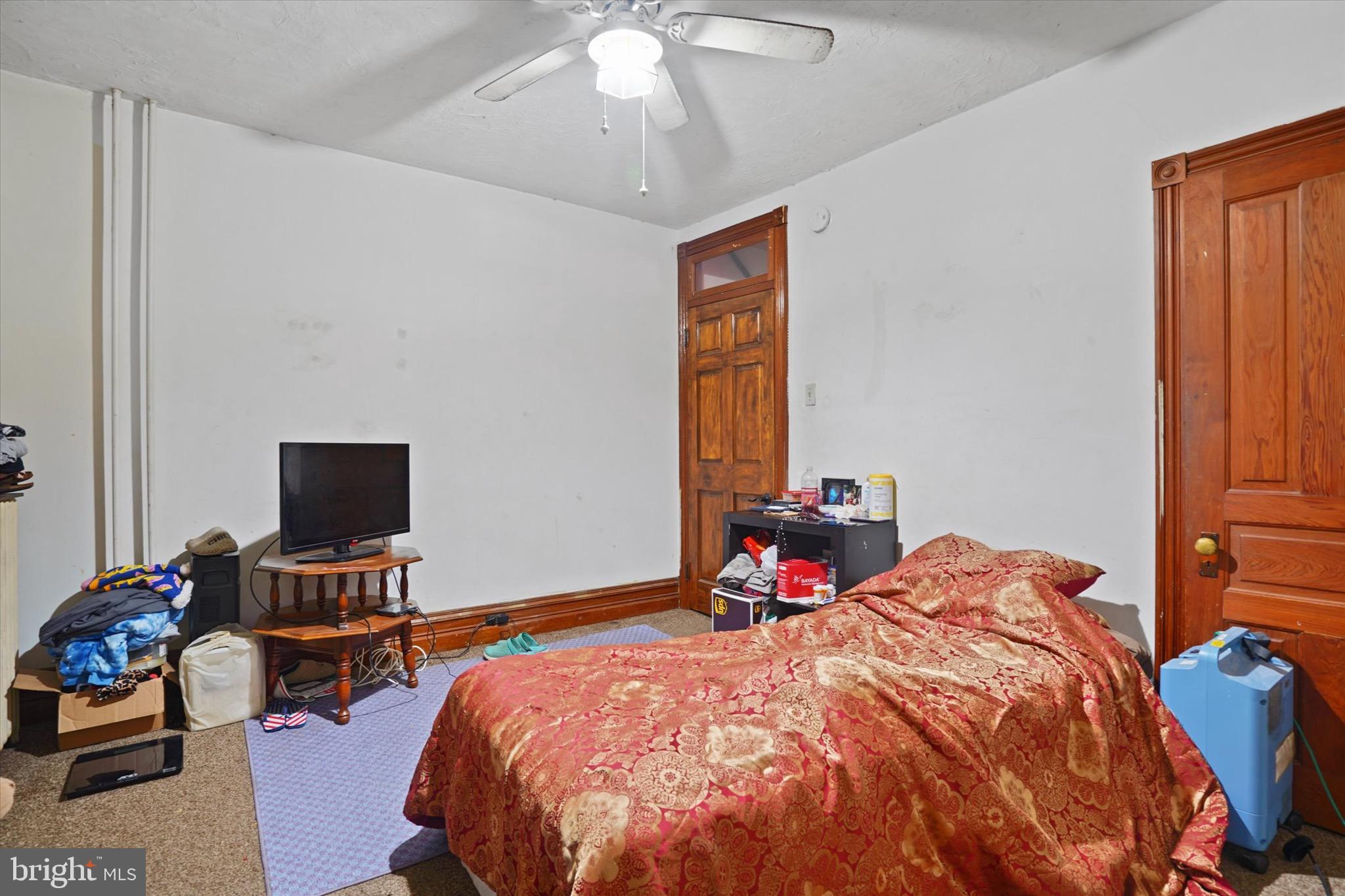 933 North 12th Street Reading, PA 19604 - Photo 12 of 26 a bed sitting in a bedroom next to a window