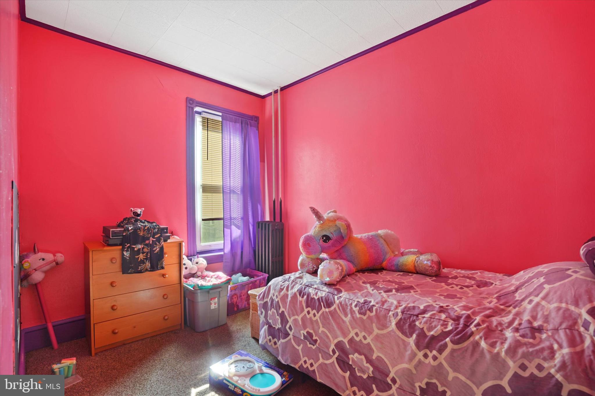 933 North 12th Street Reading, PA 19604 - Photo 13 of 26 a bedroom with a bed and a window