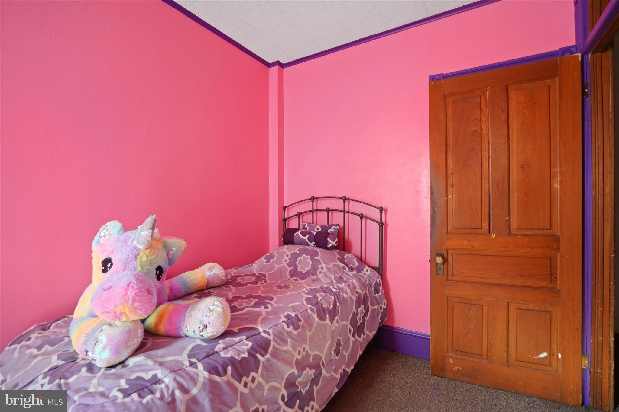 933 North 12th Street Reading, PA 19604 - Photo 14 of 26 a bedroom with a bed and a dresser with wooden floor