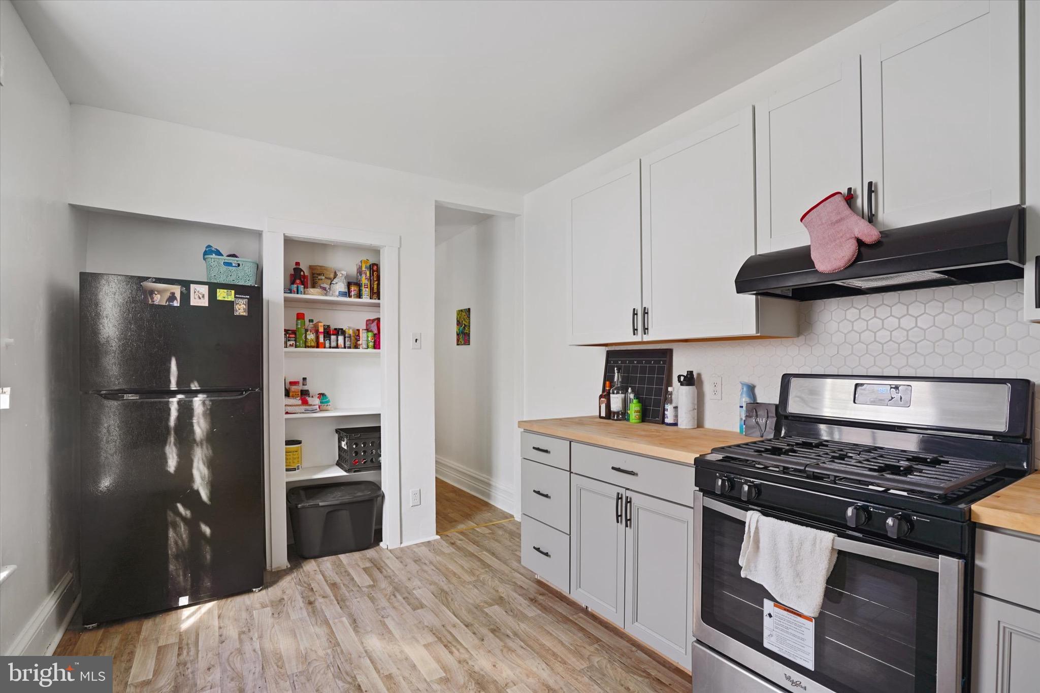 933 North 12th Street Reading, PA 19604 - Photo 20 of 26 a kitchen with stainless steel appliances granite countertop a stove a refrigerator and a refrigerator