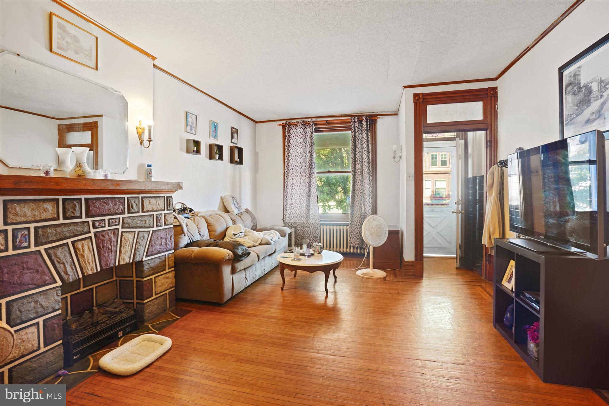 933 North 12th Street Reading, PA 19604 - Photo 5 of 26 a living room with furniture and a flat screen tv