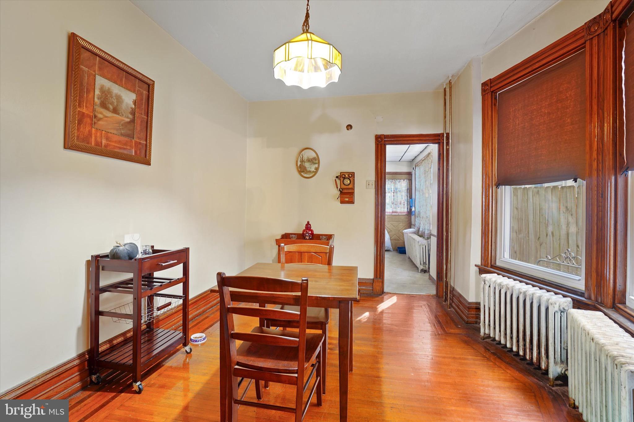 933 North 12th Street Reading, PA 19604 - Photo 7 of 26 a dining room with furniture a chandelier and wooden floor