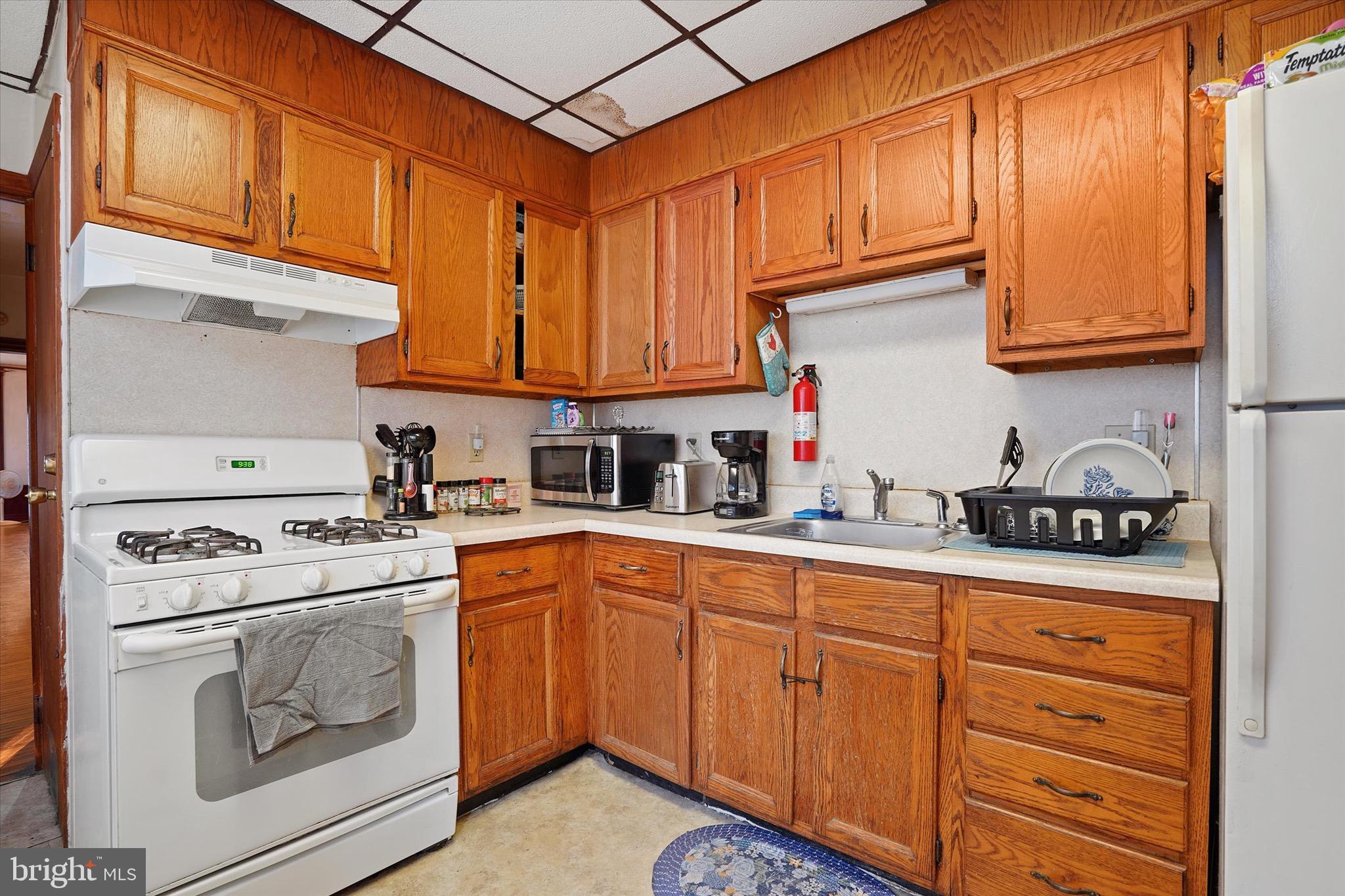 933 North 12th Street Reading, PA 19604 - Photo 8 of 26 a kitchen with granite countertop cabinets stainless steel appliances and a sink