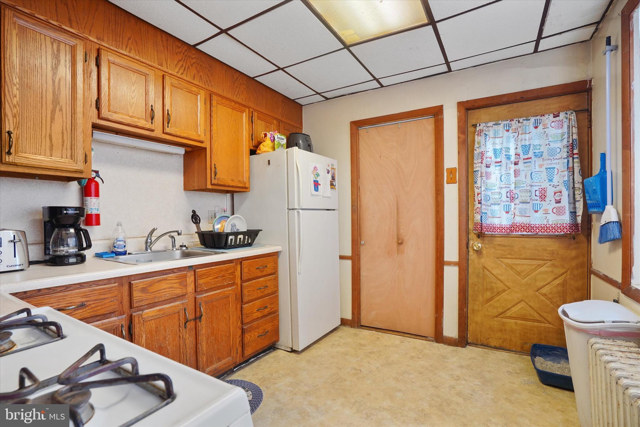 933 North 12th Street Reading, PA 19604 - Photo 9 of 26 a kitchen with stainless steel appliances granite countertop a refrigerator and a sink