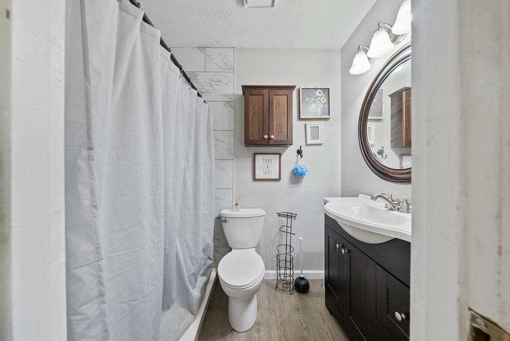 831 53rd Street Columbus, GA 31904 - Photo 14 of 37 a bathroom with a toilet sink vanity and mirror