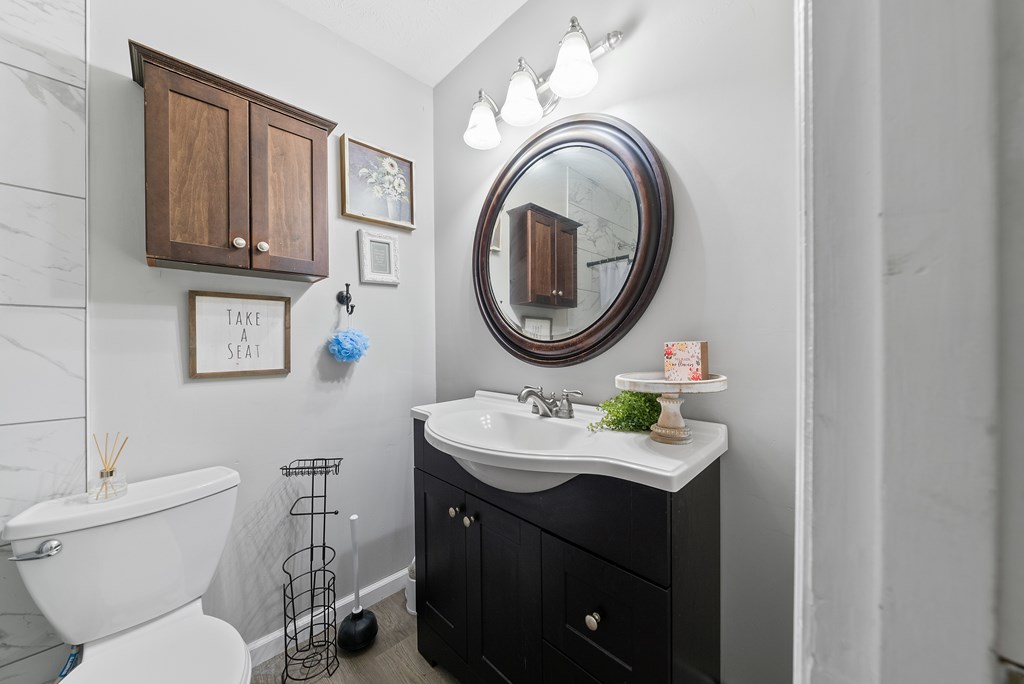 831 53rd Street Columbus, GA 31904 - Photo 15 of 37 a bathroom with a sink vanity mirror and toilet