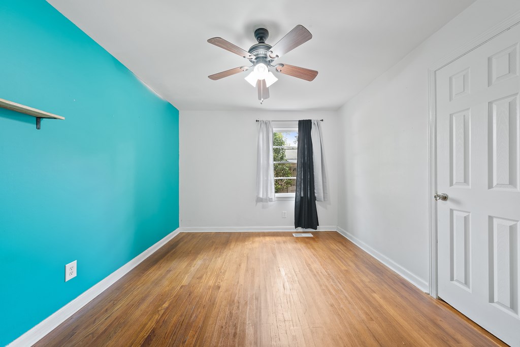 831 53rd Street Columbus, GA 31904 - Photo 19 of 37 a view of an empty room with wooden floor and a window