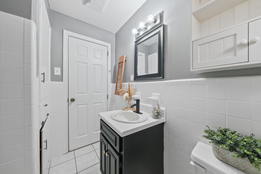 831 53rd Street Columbus, GA 31904 - Photo 20 of 37 a bathroom with a sink a vanity and a mirror