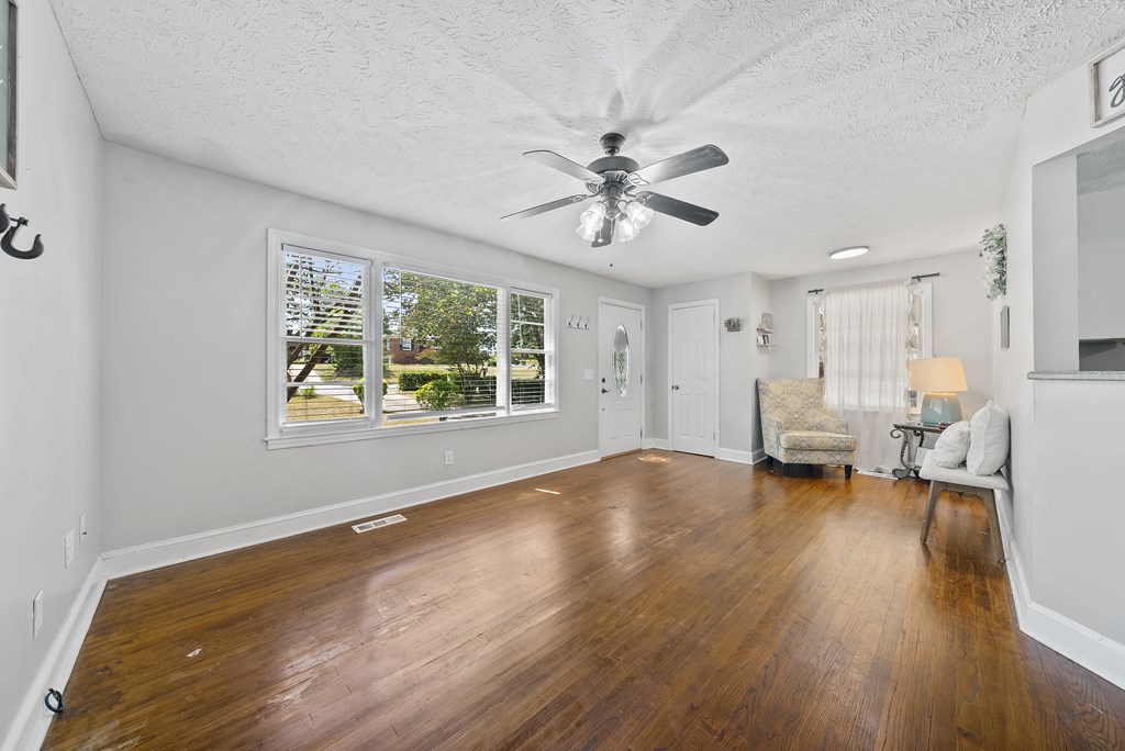 831 53rd Street Columbus, GA 31904 - Photo 4 of 37 a view of empty room with wooden floor and fan