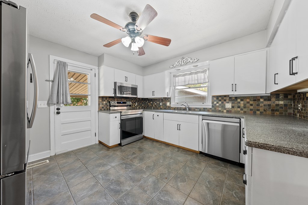 831 53rd Street Columbus, GA 31904 - Photo 9 of 37 a kitchen with granite countertop stainless steel appliances cabinets a sink and a counter top space
