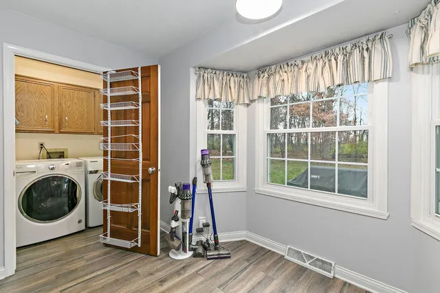 a view of a big room with wooden floor and windows
