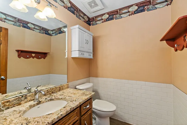 a bathroom with a sink a toilet and shower curtain