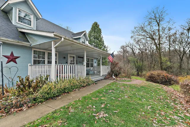a view of a house with a yard and potted plants
