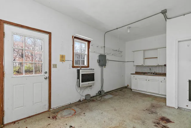 a kitchen with white cabinets and white appliances