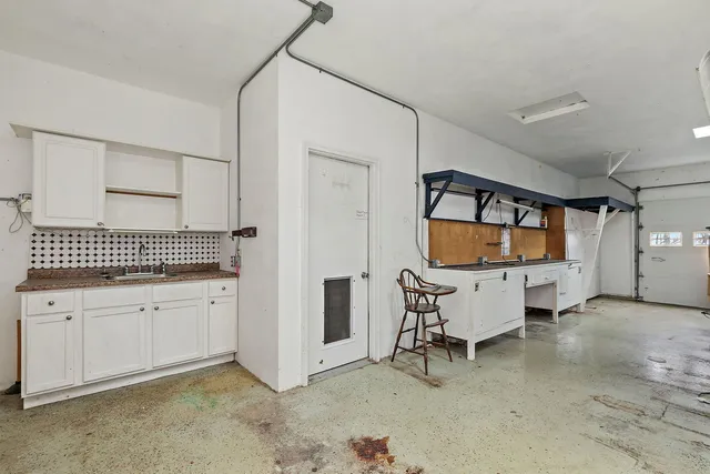 a view of a house with a yard covered in the forest
