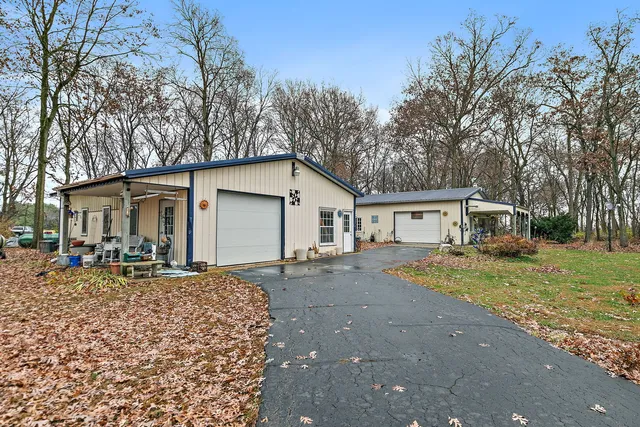 a view of a house with backyard and sitting area