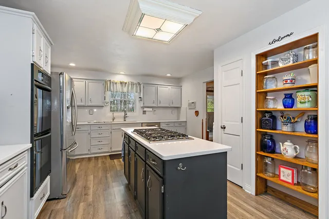 a kitchen with stainless steel appliances a refrigerator and a stove top oven