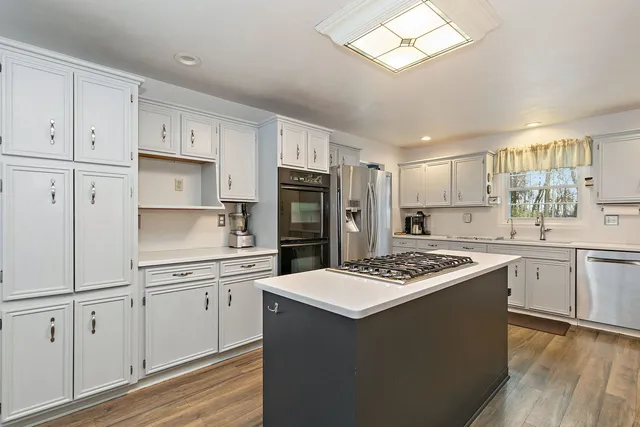 a kitchen with stainless steel appliances a refrigerator sink and cabinets