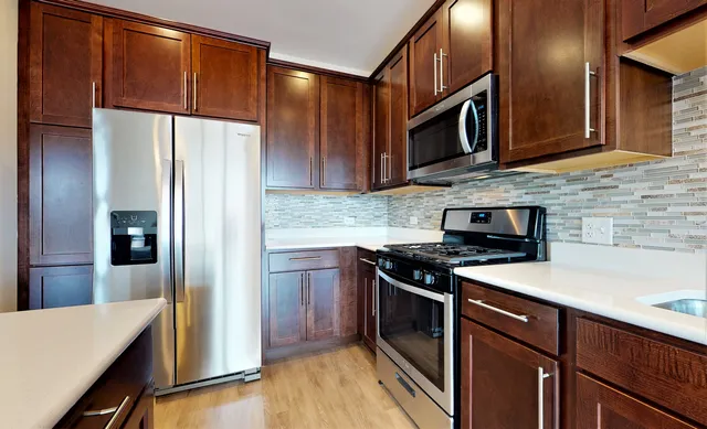 a bathroom with a sink a vanity a large mirror and a shower