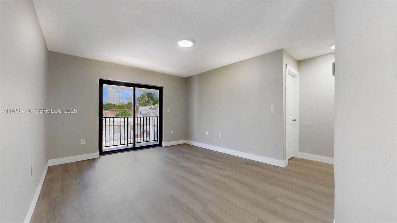 329 Southwest 9th Avenue Miami, FL 33130 - Photo 22 of 97 an empty room with wooden floor and windows