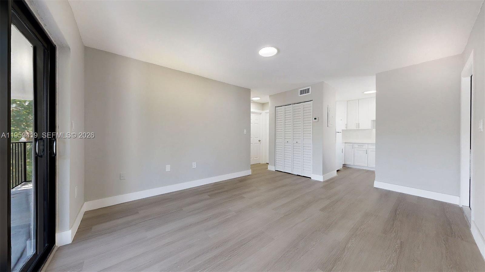 329 Southwest 9th Avenue Miami, FL 33130 - Photo 24 of 97 a view of an empty room with wooden floor and a window