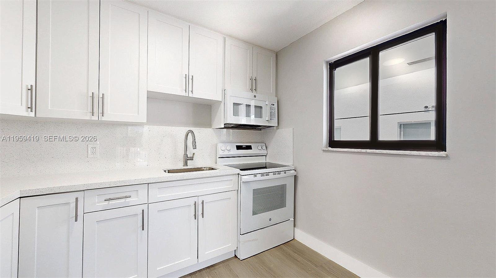329 Southwest 9th Avenue Miami, FL 33130 - Photo 30 of 97 a kitchen with white cabinets and white appliances