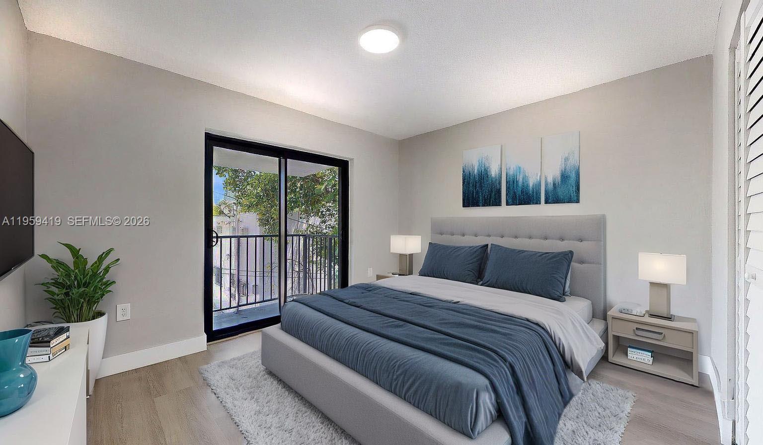 329 Southwest 9th Avenue Miami, FL 33130 - Photo 34 of 97 a bedroom with a large bed and a potted plant