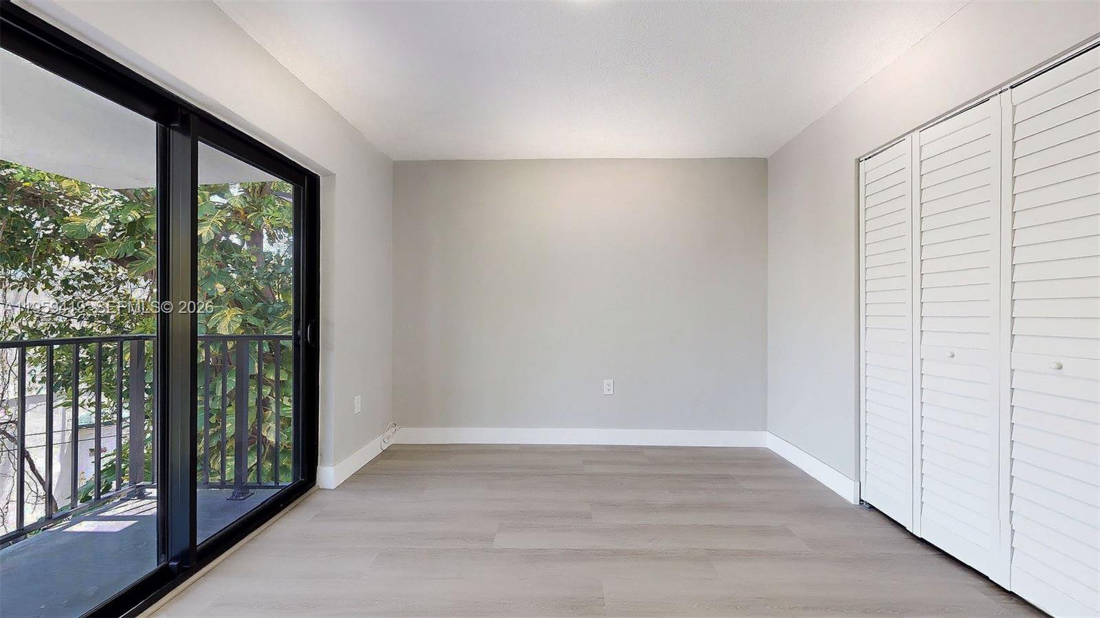 329 Southwest 9th Avenue Miami, FL 33130 - Photo 35 of 97 a view of an empty room with wooden floor and a window