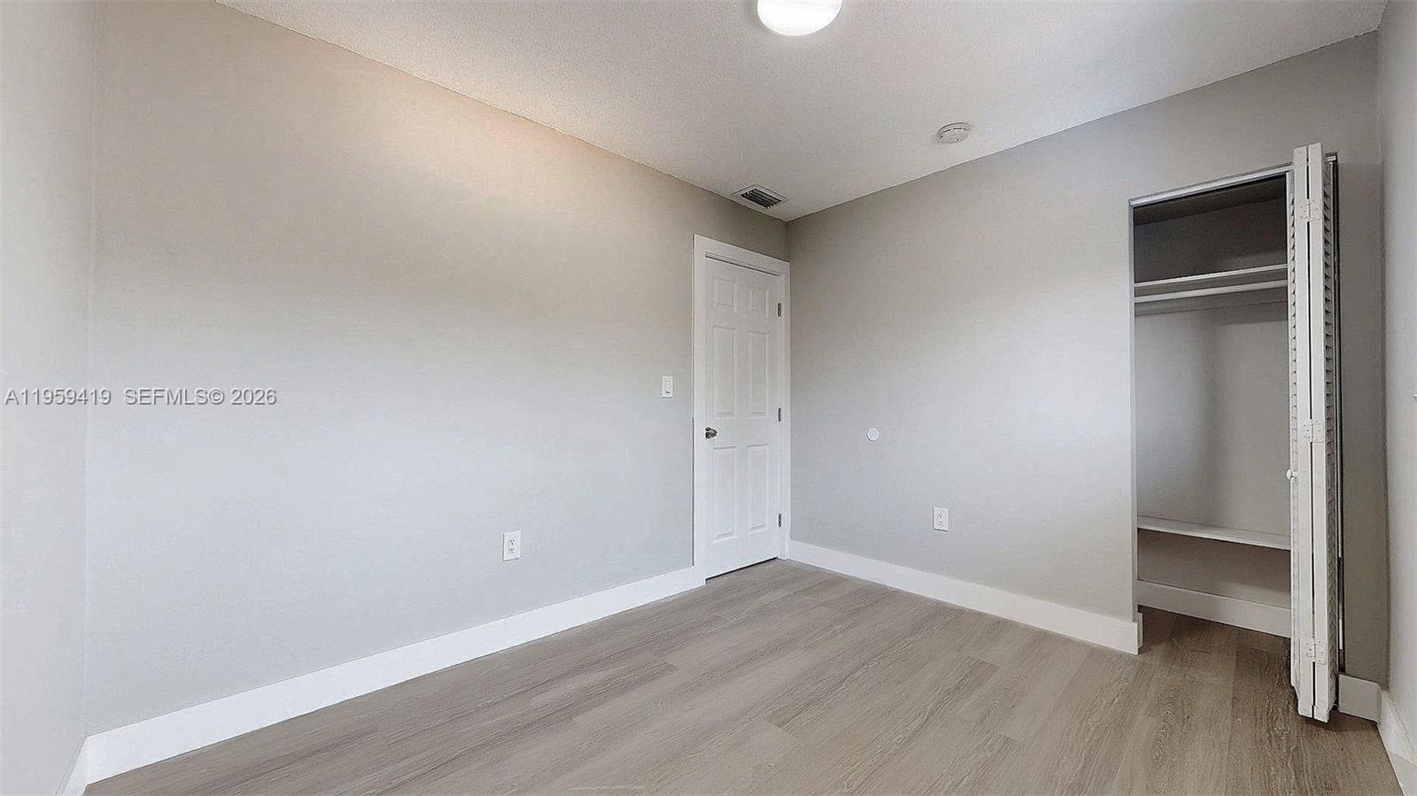 329 Southwest 9th Avenue Miami, FL 33130 - Photo 40 of 97 a view of an empty room with wooden floor