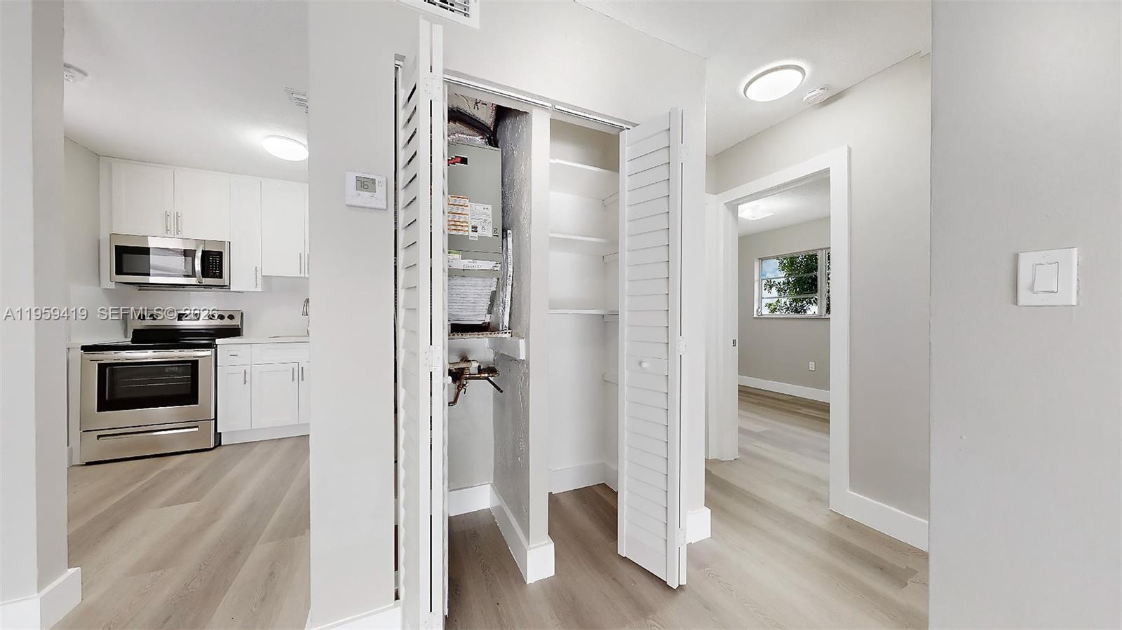 329 Southwest 9th Avenue Miami, FL 33130 - Photo 54 of 97 a view of a kitchen from the hallway with a sink and a refrigerator