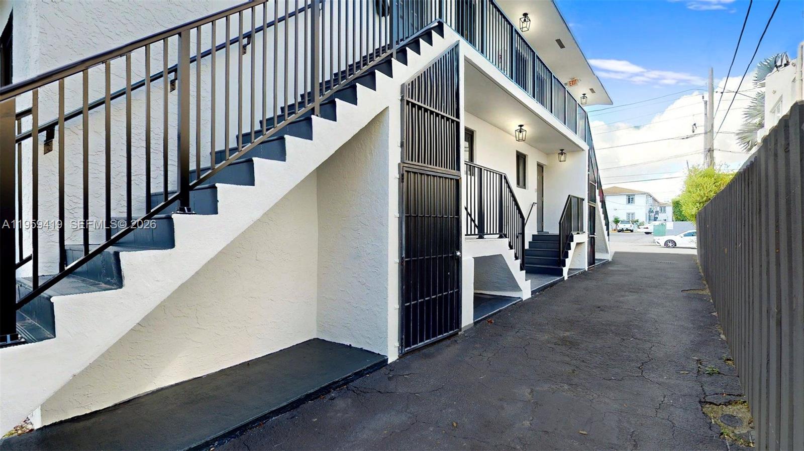 329 Southwest 9th Avenue Miami, FL 33130 - Photo 7 of 97 a view of staircase with lots of frames on wall and wooden floor