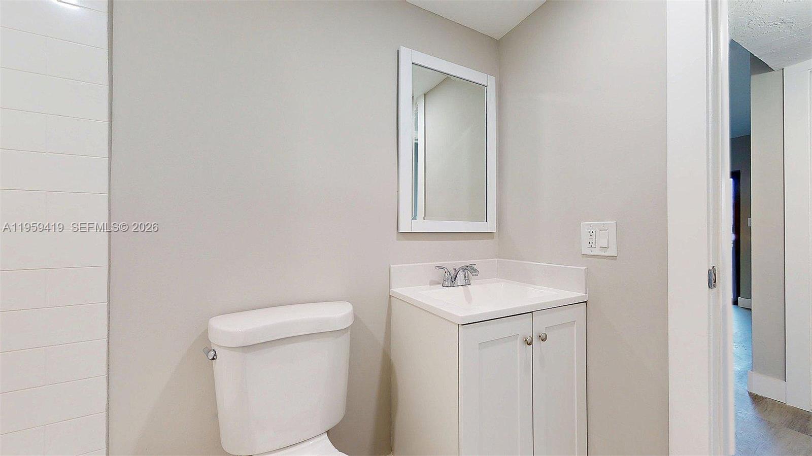 329 Southwest 9th Avenue Miami, FL 33130 - Photo 76 of 97 a bathroom with a toilet a sink a vanity and mirror
