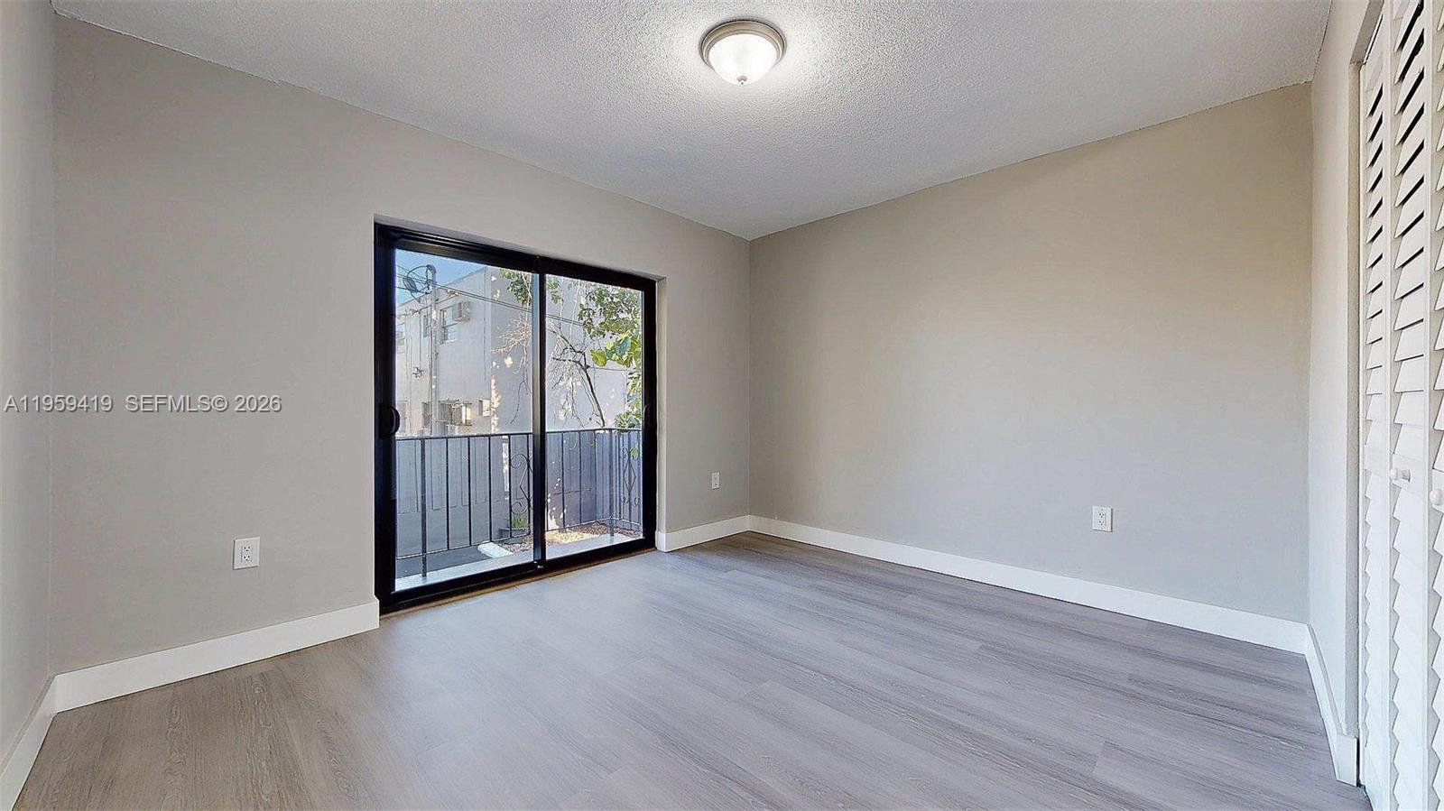 329 Southwest 9th Avenue Miami, FL 33130 - Photo 78 of 97 an empty room with wooden floor and windows