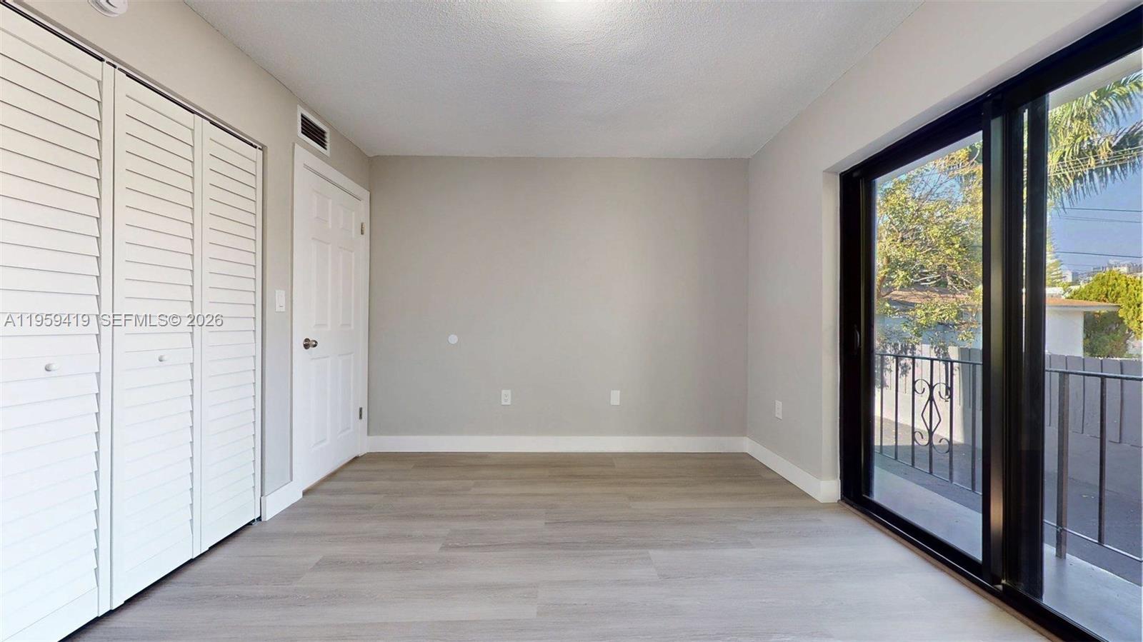 329 Southwest 9th Avenue Miami, FL 33130 - Photo 82 of 97 a view of an empty room with wooden floor and a window