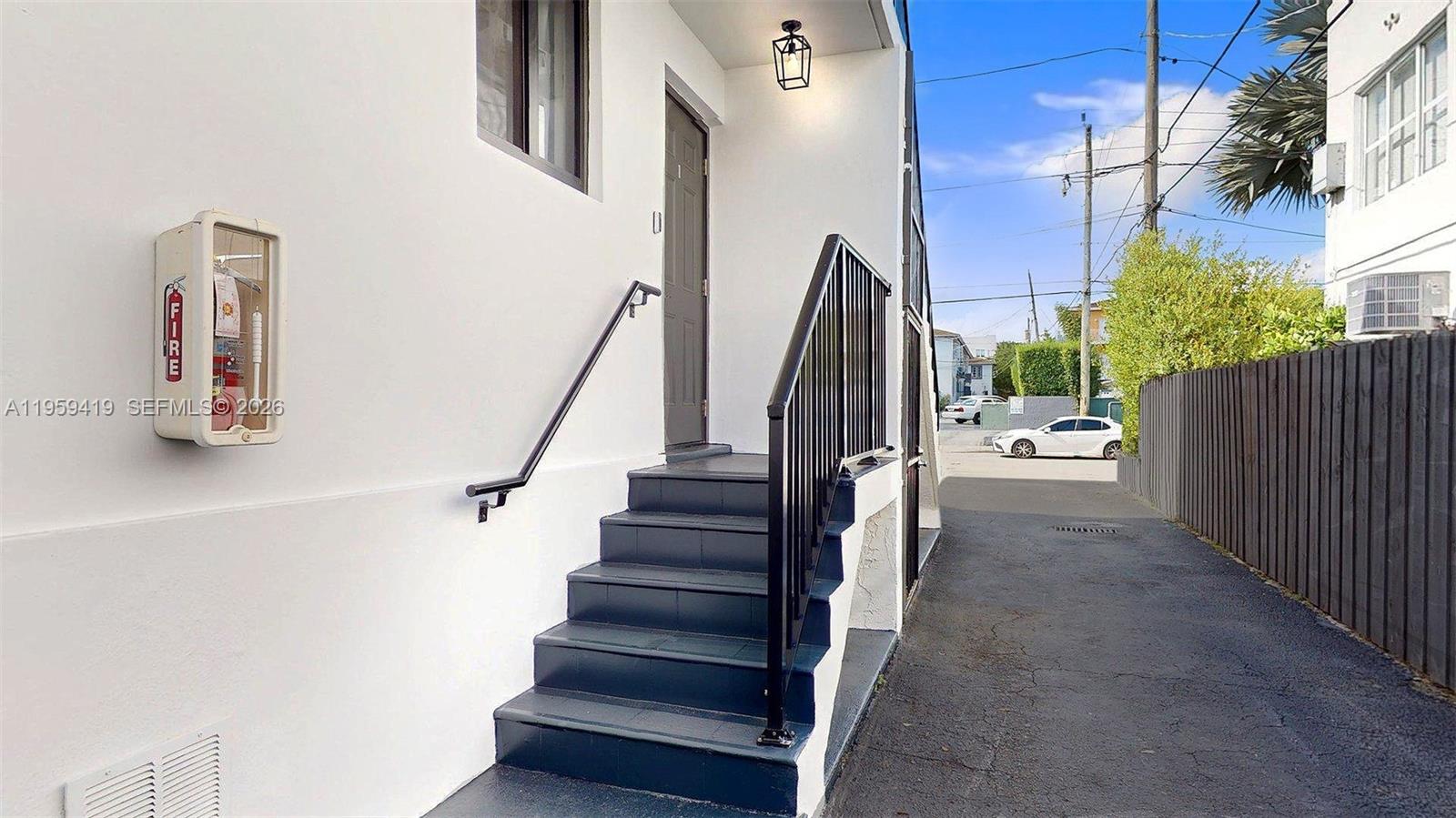 329 Southwest 9th Avenue Miami, FL 33130 - Photo 9 of 97 a view of staircase with lots of frames on wall and a potted plant