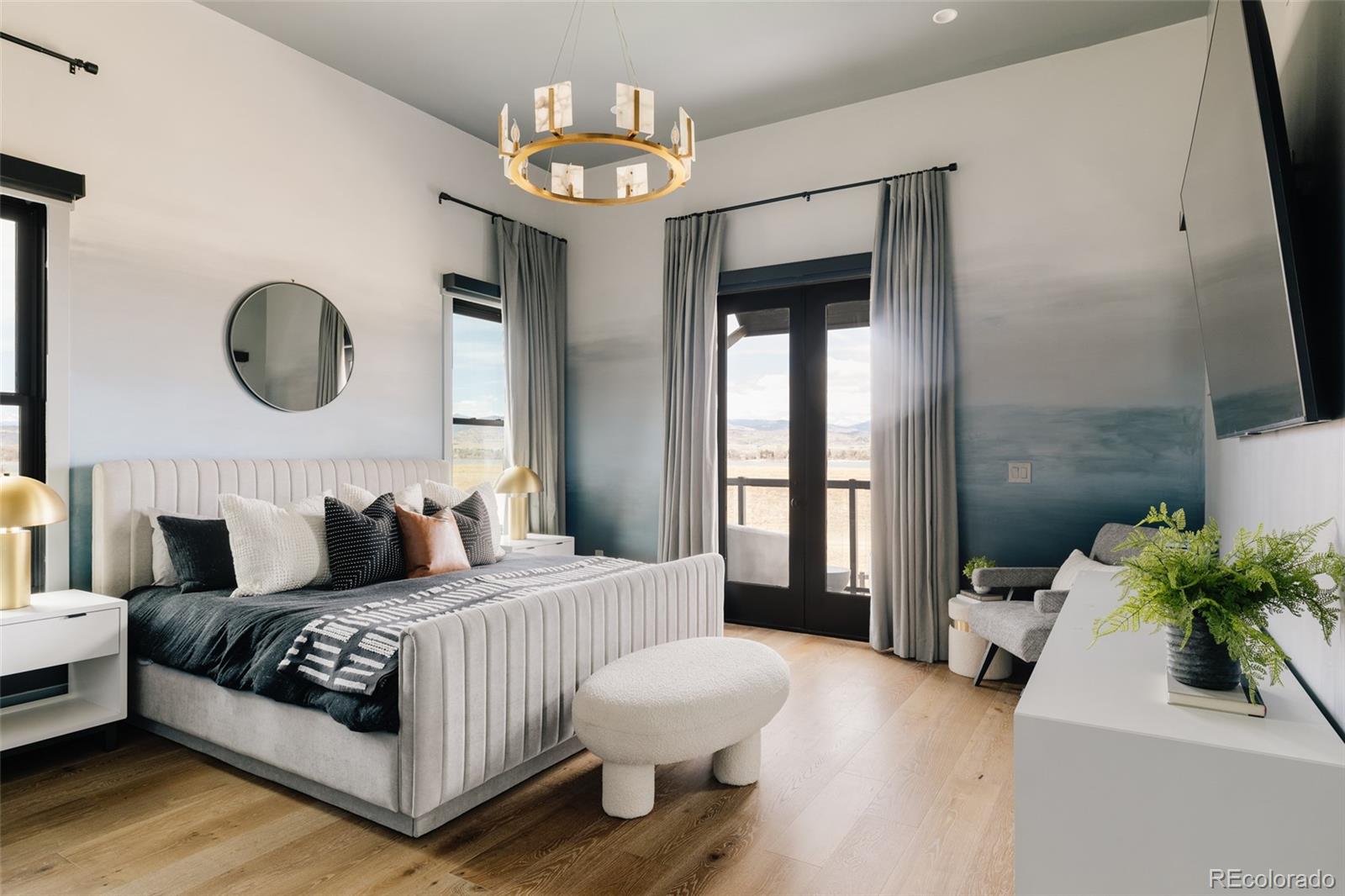 2531 Southwind Road Berthoud, CO 80513 - Photo 11 of 49 a bedroom with a bed and a chandelier