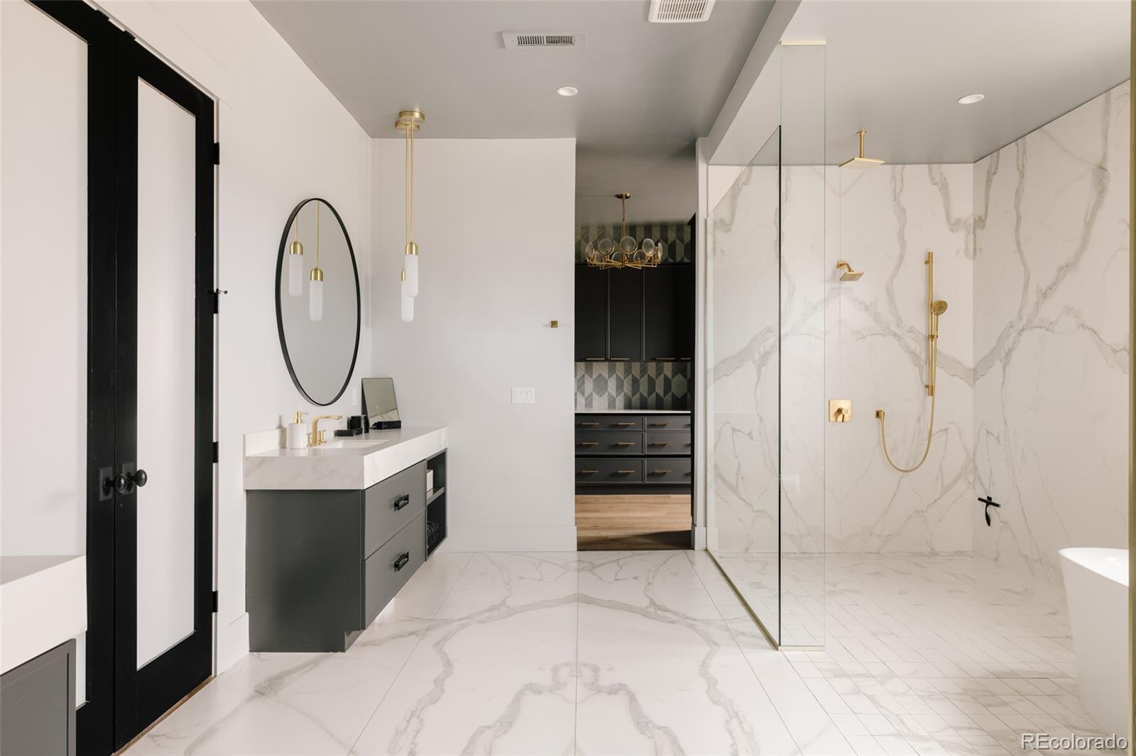 2531 Southwind Road Berthoud, CO 80513 - Photo 14 of 49 a spacious bathroom with a double vanity sink a mirror and a shower