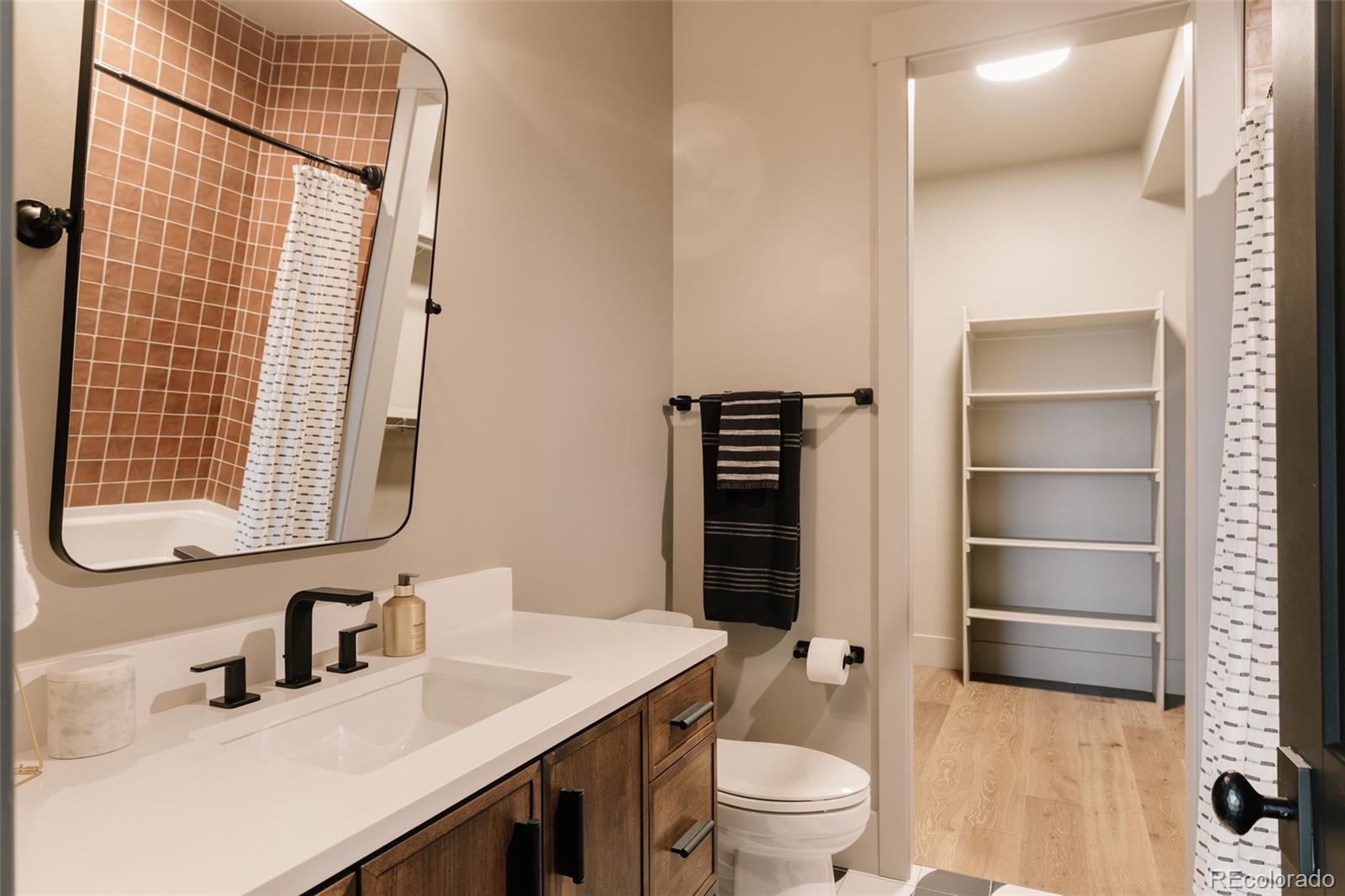 2531 Southwind Road Berthoud, CO 80513 - Photo 30 of 49 a bathroom with a sink a toilet and shower