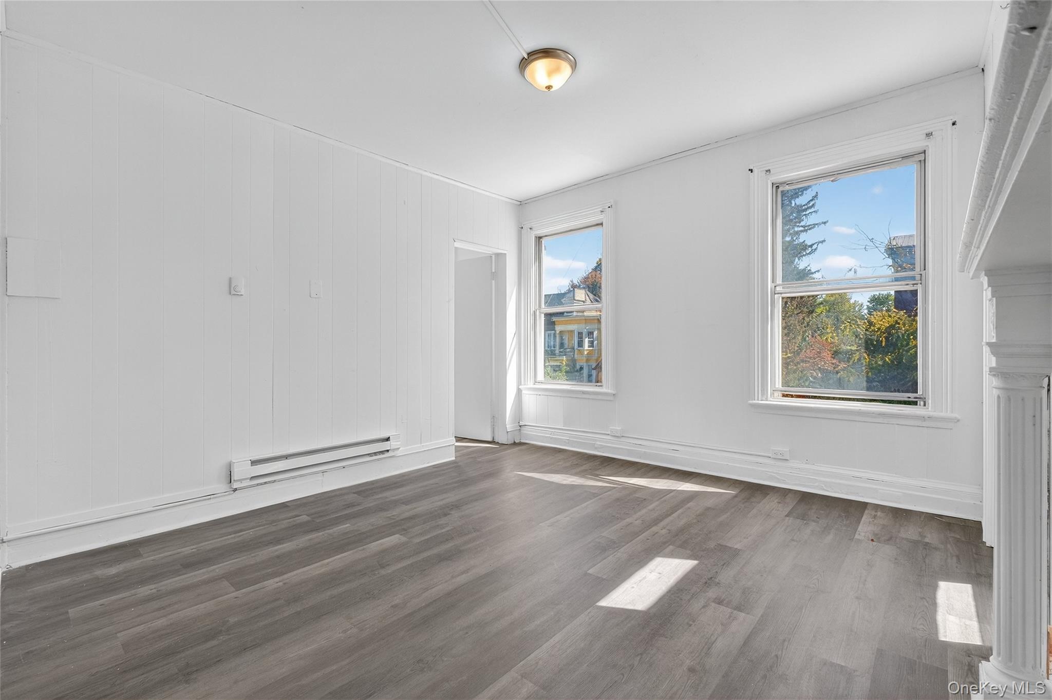 49 South Hamilton Street, Unit 2 Poughkeepsie, NY 12601 - Photo 9 of 20 an empty room with wooden floor and windows