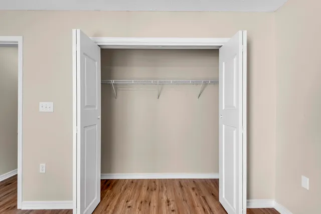 a view of a room with wooden floor