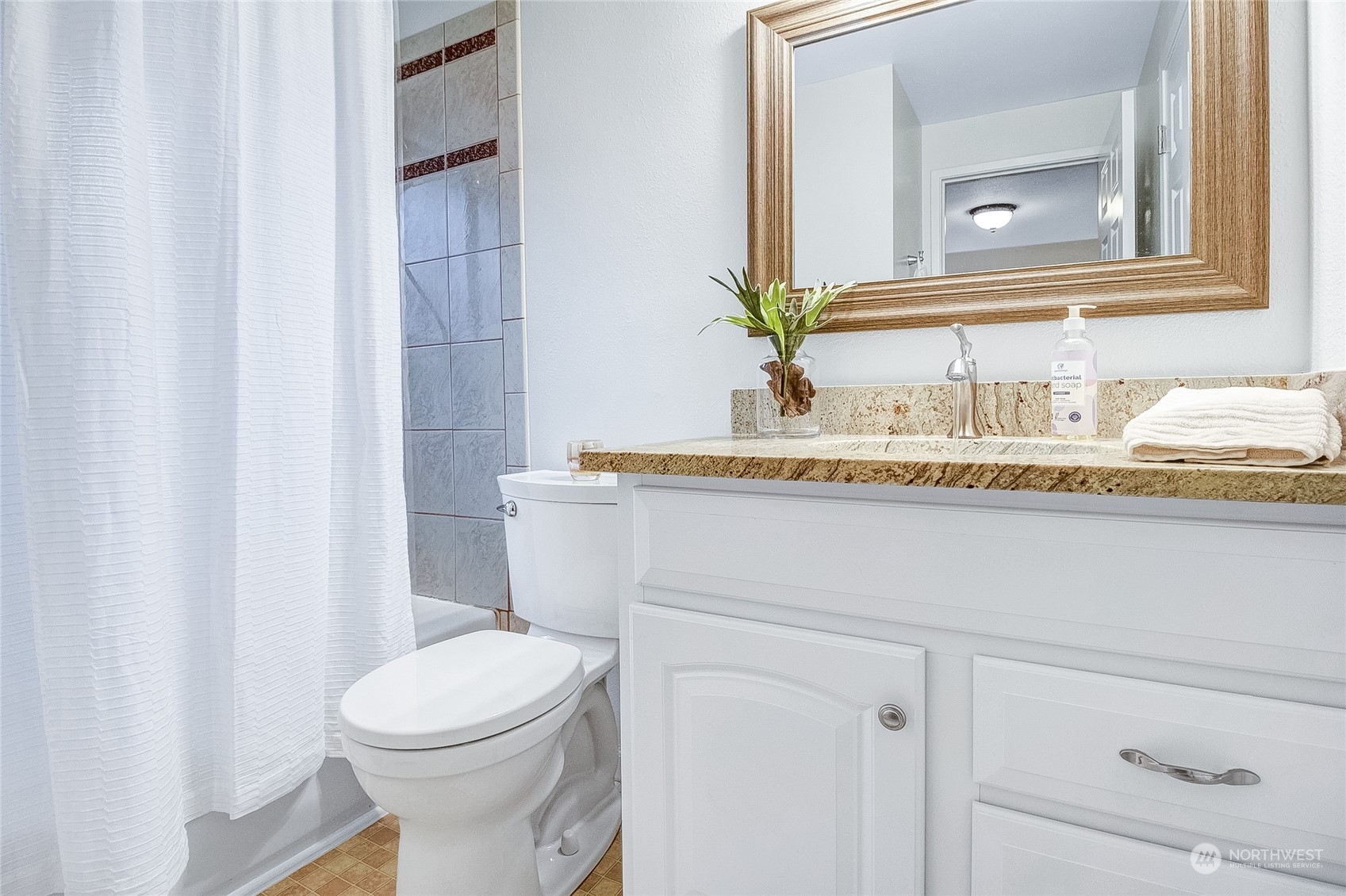 11820 Northeast 158th Street Bothell, WA 98011 - Photo 17 of 28 a bathroom with a granite countertop toilet sink and mirror