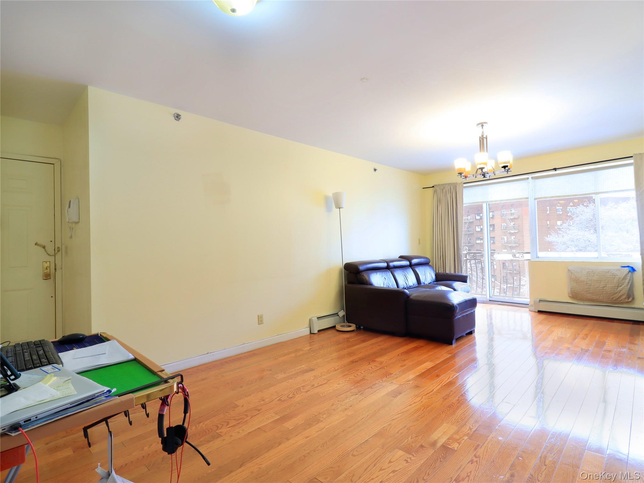 137-08 31st Road, Unit 5E Queens, NY 11354 - Photo 6 of 13 a bedroom with a bed and a couch