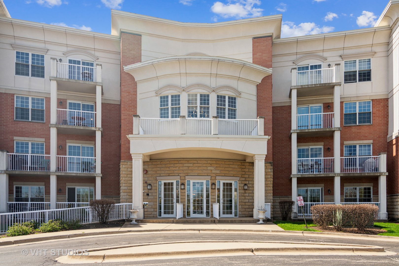 701 West Rand Road, Unit 423 Arlington Heights, IL 60004 - Photo 1 of 15 a view of a building with a clock on a wall