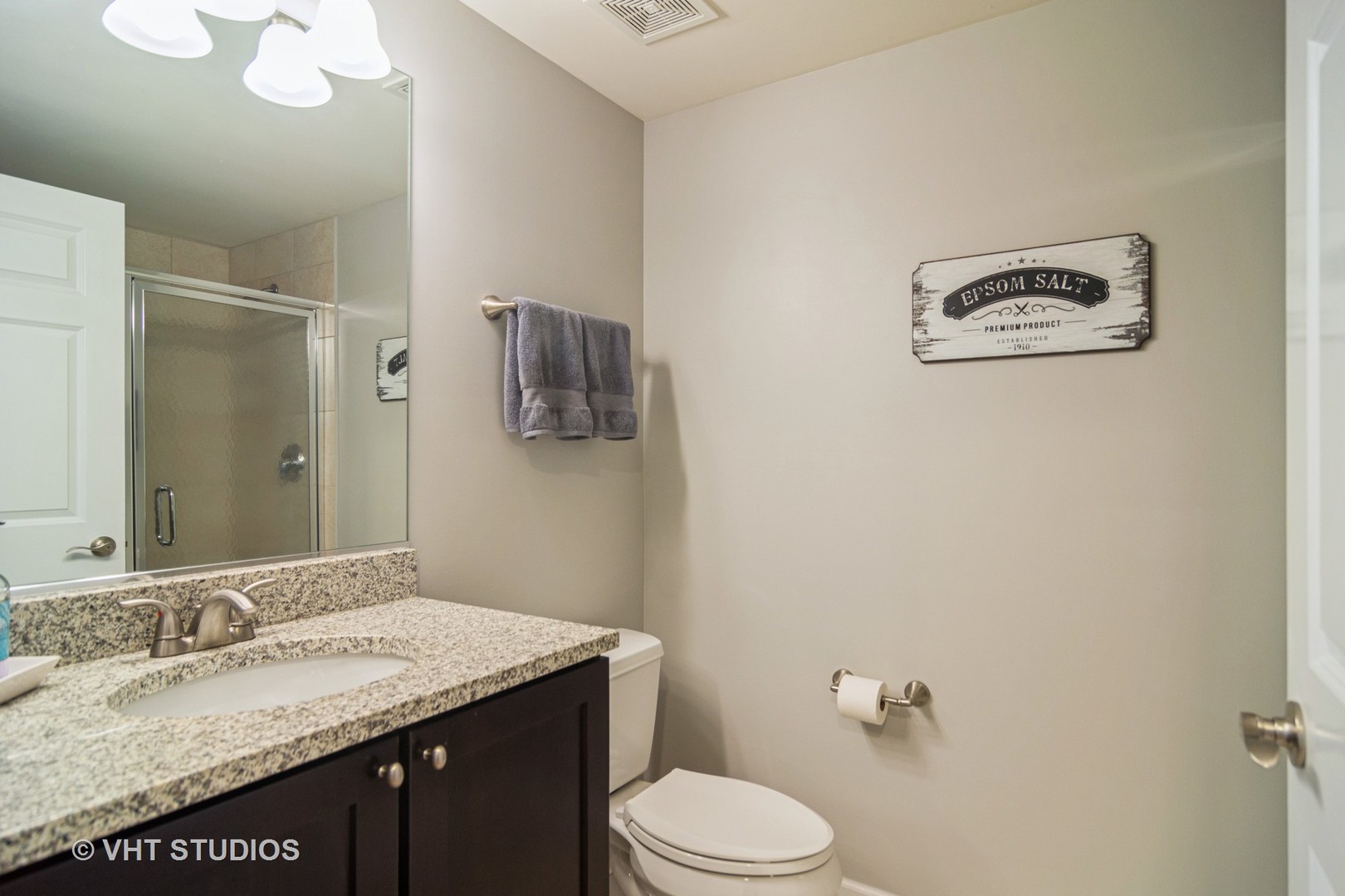 701 West Rand Road, Unit 423 Arlington Heights, IL 60004 - Photo 12 of 15 a bathroom with a granite countertop sink mirror vanity and toilet