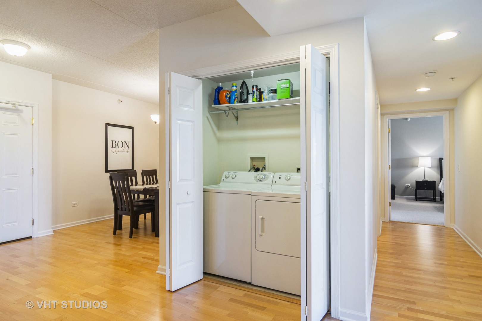 701 West Rand Road, Unit 423 Arlington Heights, IL 60004 - Photo 13 of 15 a view of a hallway to dining room with wooden floor and furniture
