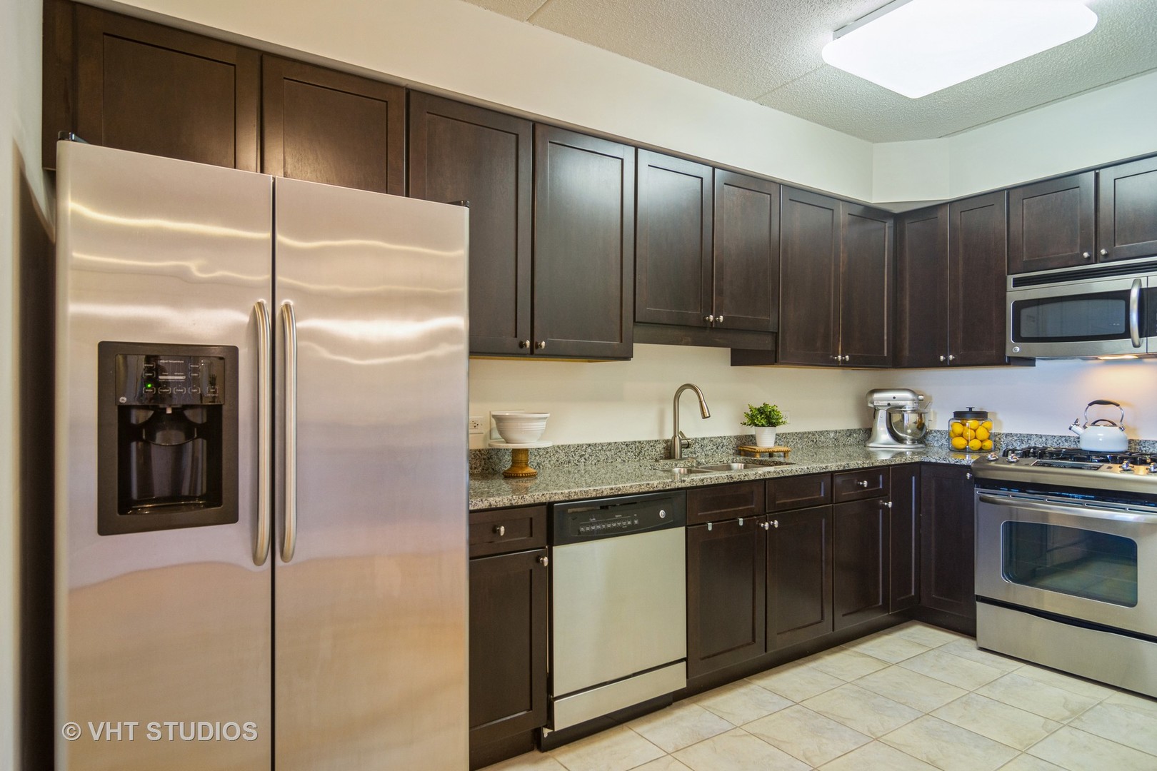 701 West Rand Road, Unit 423 Arlington Heights, IL 60004 - Photo 5 of 15 a kitchen with stainless steel appliances granite countertop a refrigerator and a sink