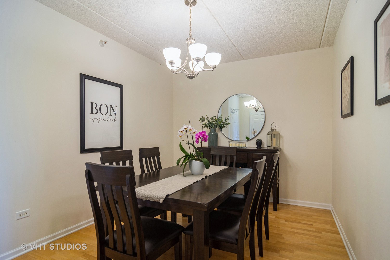 701 West Rand Road, Unit 423 Arlington Heights, IL 60004 - Photo 7 of 15 a view of a dining room with furniture a chandelier and wooden floor