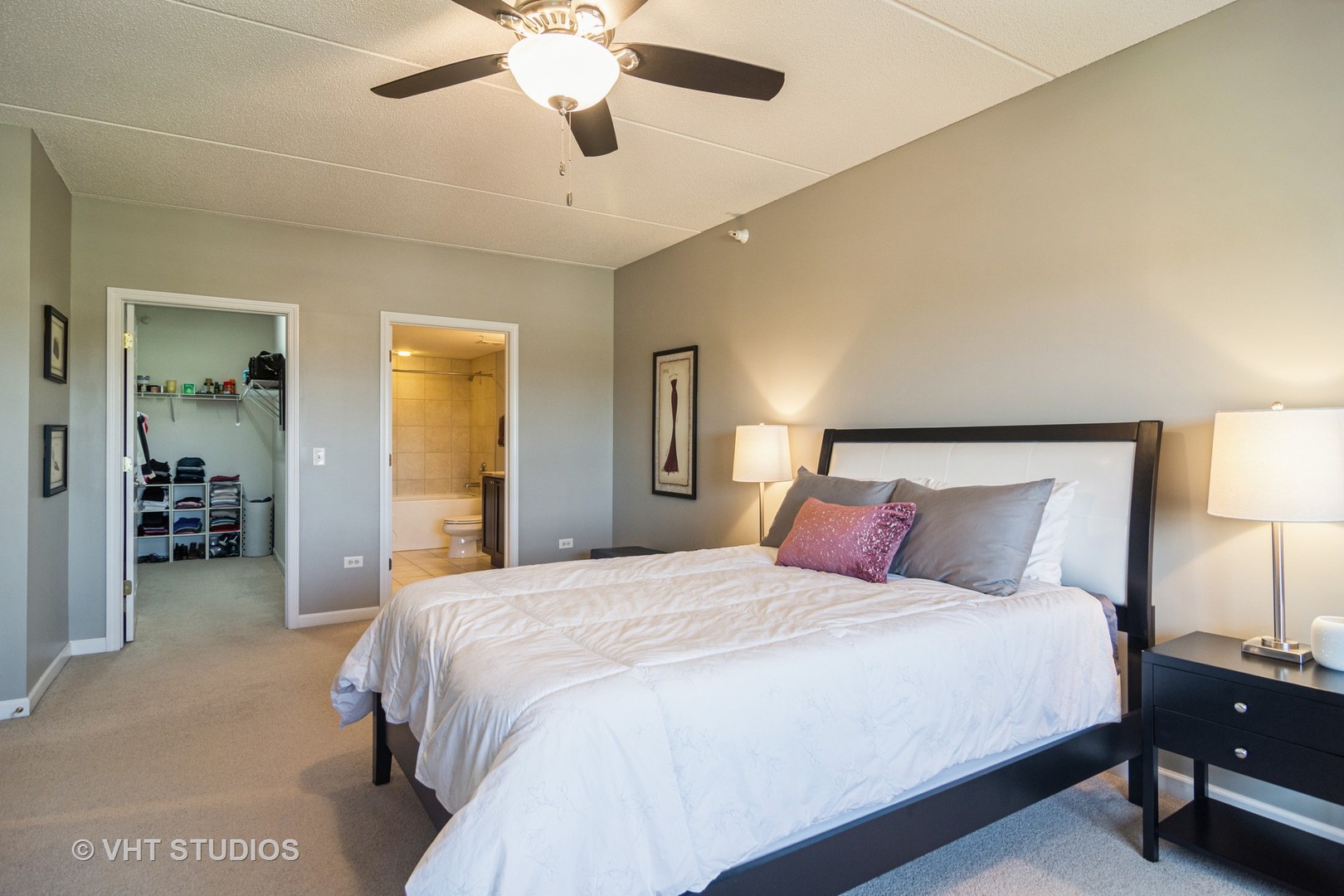 701 West Rand Road, Unit 423 Arlington Heights, IL 60004 - Photo 9 of 15 a bedroom with a large bed and a chandelier