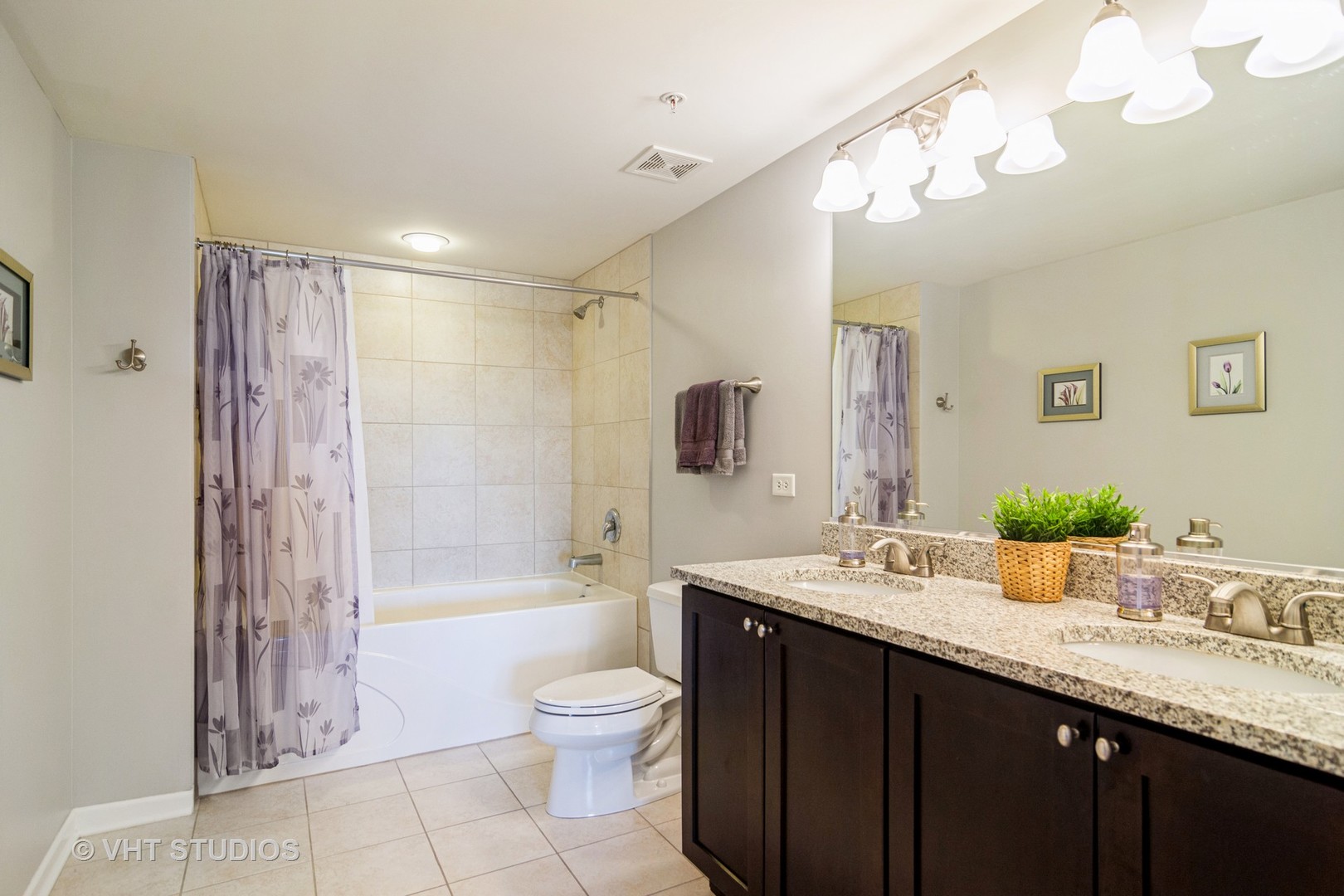 701 West Rand Road, Unit 423 Arlington Heights, IL 60004 - Photo 10 of 15 a bathroom with a granite countertop sink a toilet a mirror a vanity and shower